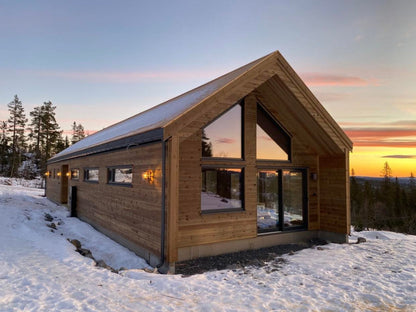 Modern timber frame panel private house in Latvia with large panoramic windows on the front facade